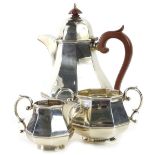 A George V silver three piece tea set, comprising teapot with composition knop and handle, milk