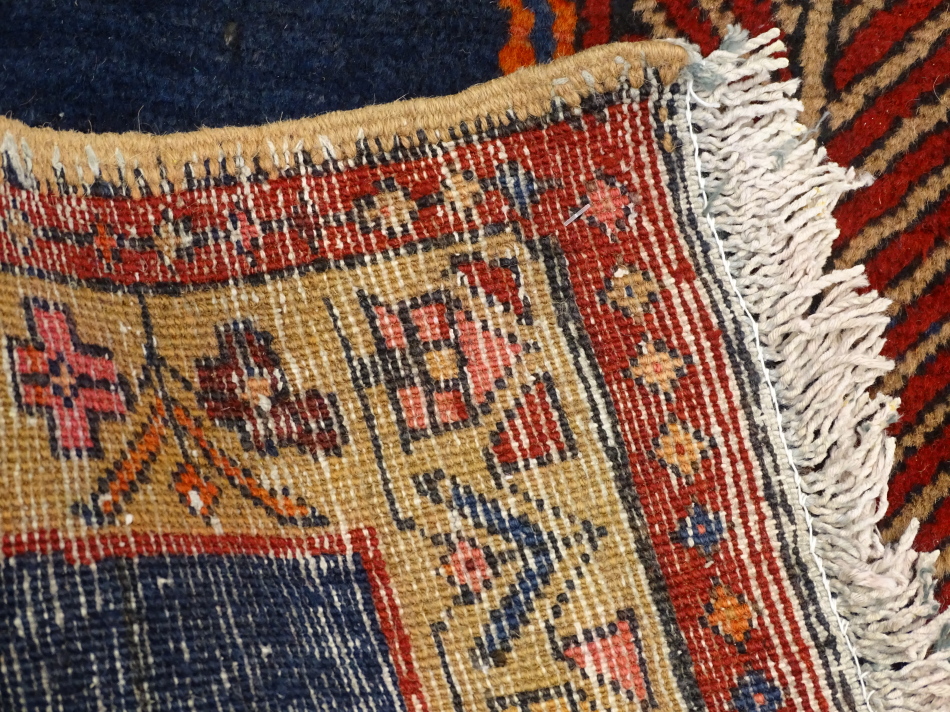 An Azari runner, with a long pole type medallion in red, orange, pink etc., on a navy ground with - Image 3 of 3