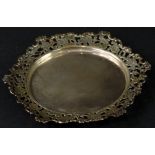 A Continental white metal dish, with elaborate pierced border, decorated with scrolls, flowers,