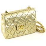 A Chanel Classic mini gold quilted bag, with CC twist lock closure and leather woven shoulder strap,