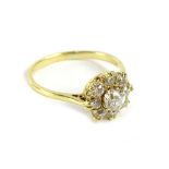 An 18ct gold diamond cluster ring, with central old cut diamond approx 0.70cts, in claw setting,