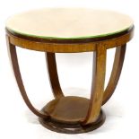 An Art Deco walnut two tier table, the circular top with shaped supports.
