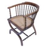 A Continental beech tub shaped chair, the shaped back on bobbin turned supports, with a cane seat,