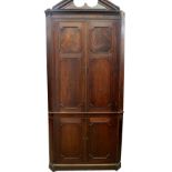 A George III mahogany standing corner cupboard, with dentil moulded broken arch pediment, two double