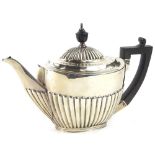 A late Victorian silver teapot, with part fluted body, ebonised knop and handle, London 1897, 14oz