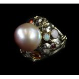 A pearl and gemstone set Arts & Crafts style ring, with foliate twist design, set with citrines,