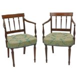 A pair of late George III mahogany open armchairs, each with a bar back and reeded turned tapering