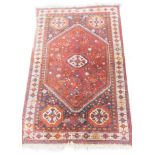 Two similar Turkish type small rugs or mats, each on an orange ground, 86cm x 65cm and 87cm x 63cm.