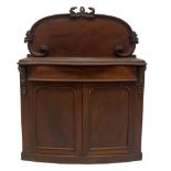 A Victorian mahogany chiffonier, with scroll carved and flamed back, serpentine moulded top,