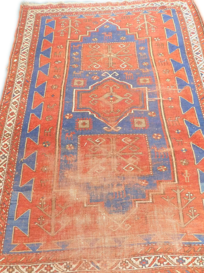 Withdrawn from sale - Retained by the Executors. A Turkish rug, with three medallions on a blue