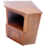 A walnut corner cabinet, with moulded edge, the frieze and panelled door carved with leaves, flowers