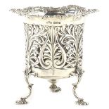 An Edwardian silver vase or basket, with a shaped rococo scroll edge, foliate pierced sides on 'C'