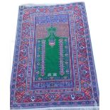 A Turkish type rug, with a directional design of an arch, on a vivid green ground, with one wide and