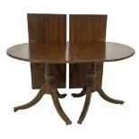 A Regency style mahogany twin pillar dining table, with moulded top and two further leaves, baluster