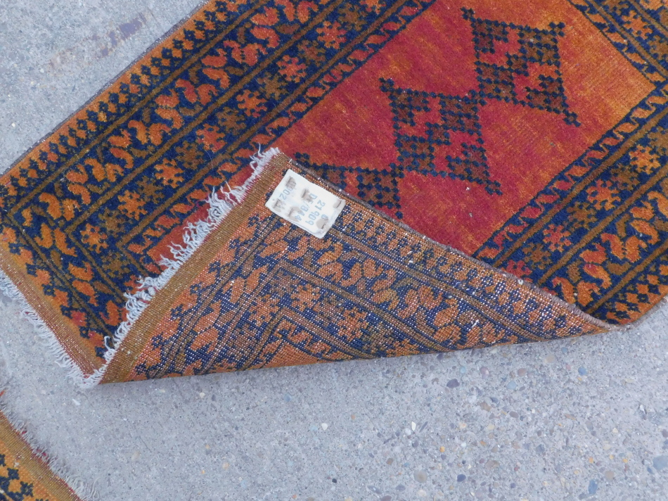 Two similar Turkish type small rugs or mats, each on an orange ground, 86cm x 65cm and 87cm x 63cm. - Image 3 of 3