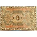 An Azari rug, with a central medallion on a red ground with one wide border, (AF), 190cm x 125cm.