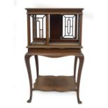 An Edwardian mahogany revolving bookcase, with boxwood strung and satin wood cross banded moulded