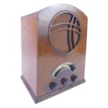 An Atlas Art Deco radio, in an arched walnut case with Bakelite knobs, 40cm H.