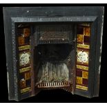 A Victorian cast iron fireplace insert, with tiled sides and cast with aesthetic roundels, flowers