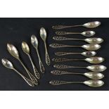 A collection of Continental white metal condiment or salt spoons, each with a foliate pierced