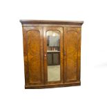 A Victorian burr and figured walnut triple wardrobe, with moulded cornice, arch moulded mirror