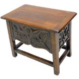 An oak work table, the rectangular hinged top enclosing a vacant interior, with a gothic style