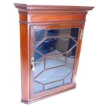 A 19thC mahogany corner cabinet, with a moulded and dentil cornice, above a single glazed door,