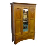 An Edwardian mahogany and marquetry wardrobe, with a moulded cornice, above a bevelled glass