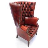 A mahogany and red leather button back porters chair, with brass studded decoration on square