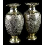 A pair of Middle Eastern white metal vases, each with chased and embossed decoration of birds,