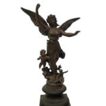 A 19thC ebonised pedestal, having a bronze patinated spelter figure of a female torch bearer
