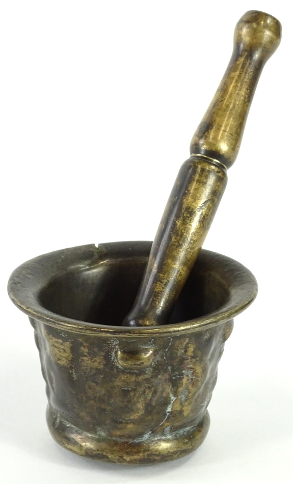 A 17thC bronze mortar, with indistinct cast decoration, 7cm H, 10cm dia. and an associated pestle,