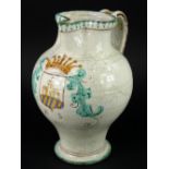 An Italian tin glazed ewer or jug, decorated with a crest and dated 1625, 35cm H.