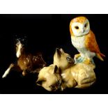 Three Beswick pieces, an owl, a pair of Siamese kittens, numbered 1296 and a seated foal.
