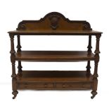 A Victorian oak serving buffet, with three moulded platforms having fluted and carved supports,