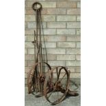 A pair of small iron plough wheels with pedals, and various blacksmith's forge tools etc.