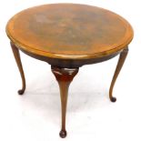 A walnut occasional table, the circular top with a cross banded and moulded edge, on cabriole legs