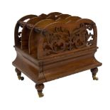 An early Victorian walnut Canterbury, with fret work end dividers solid centres and single concealed