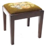 A 19thC mahogany stool, with floral woolwork padded seat, on square tapering reeded legs.