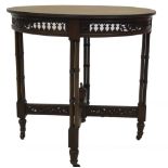 A late Victorian mahogany centre table, with circular reeded top, having a pierced fret work frieze,