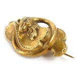 A Victorian snake design brooch, the snake wrapped around ribbon banner, of curved design, yellow