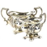 An Edwardian two handled silver sugar bowl, with embossed decoration of scrolls, etc., shaped