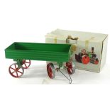 A Mamod painted metal open wagon for a steam roller, with green and red livery, boxed, 26cm W.