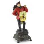 A German figural painted metal mantel clock, modelled in the form of a gentleman wearing a red and