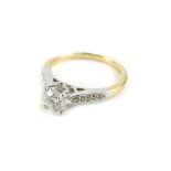 An 18ct gold and platinum diamond ring, with central round brilliant cut diamond, approx 0.78cts, in