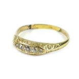 A diamond set gypsy ring, set with five round brilliant cut diamonds, with C and S scroll ring head,