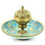 A late 19thC French brass and enamel inkwell, the hinged lid cast with scrolls etc., enclosing a