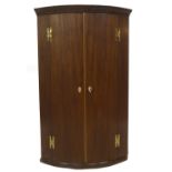 A George III mahogany bowfront hanging corner cupboard, with moulded cornice, two doors hung on