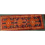 An Azari runner, with three shaped medallions on a blue ground, decorated with animals and birds,