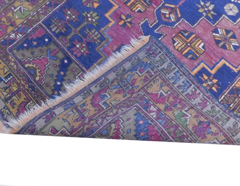 A Persian type rug, with a central pole medallion, on a maroon ground with blue spandrels, one - Image 2 of 2